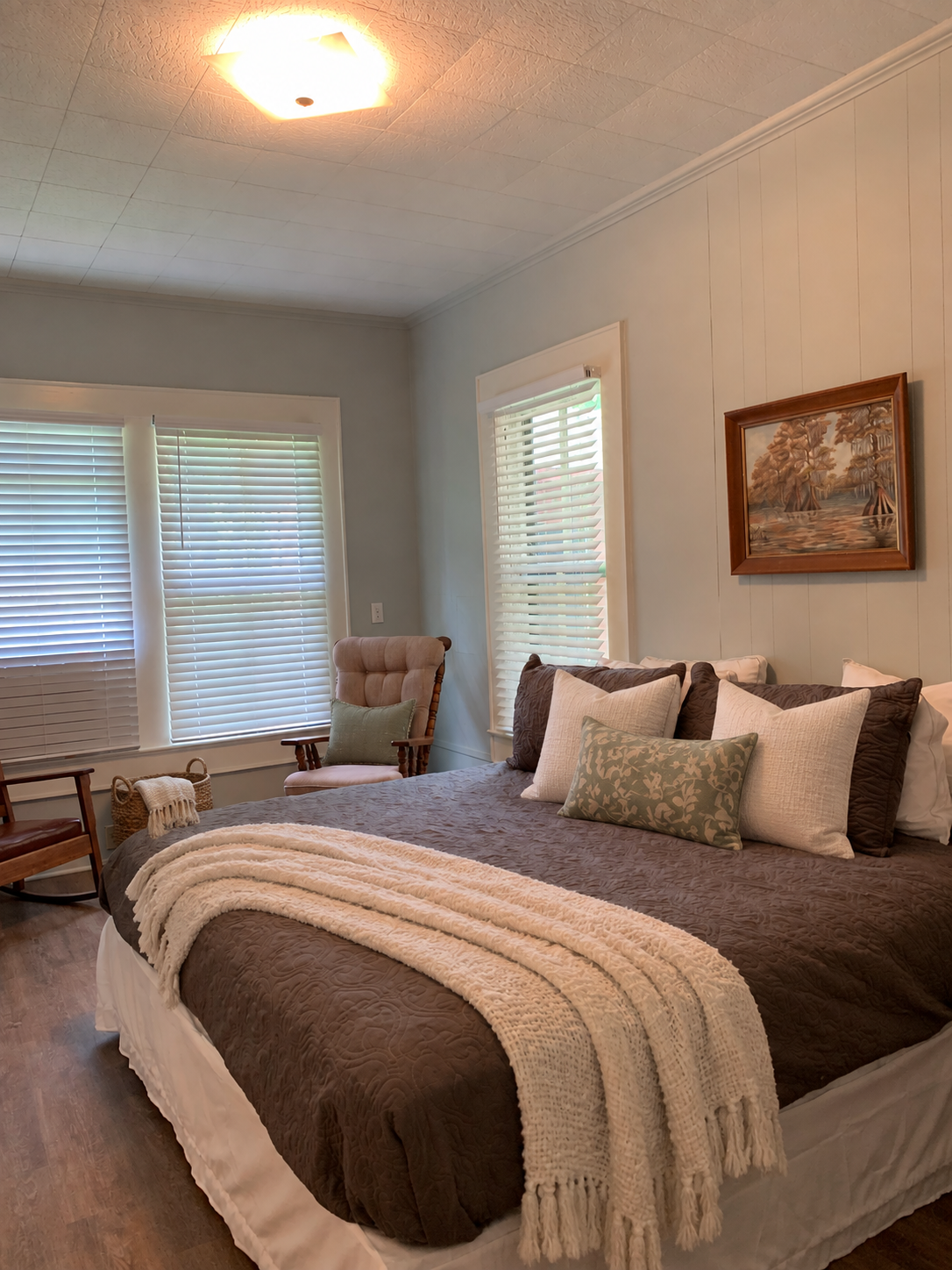 Guest bedroom with pale blue walls and king bed